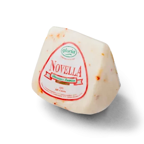 Cheese wedge with red label and visible red pepper flakes on white rind