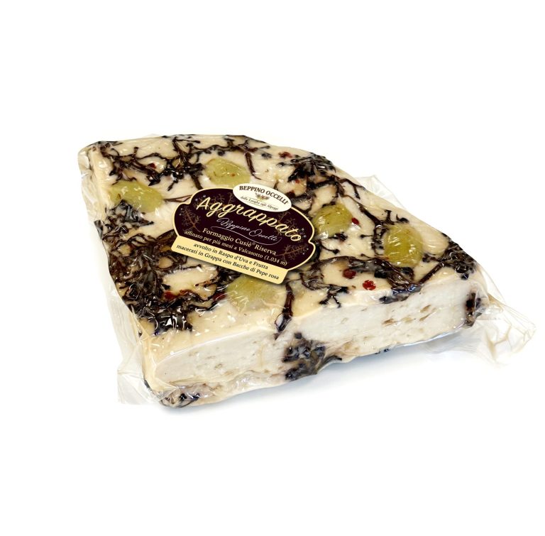 Wrapped artisanal cheese block with dark truffle-like specks