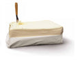 Wrapped block of pale raw butter with wooden spreader