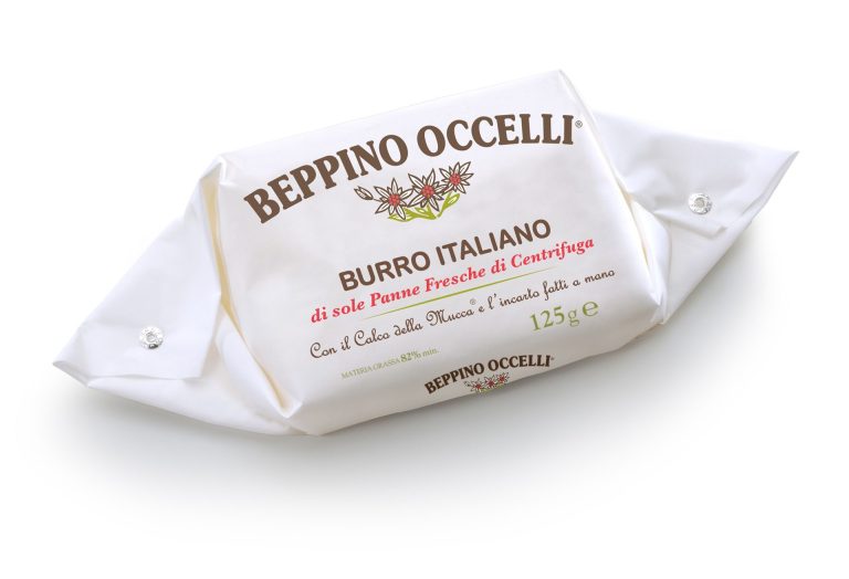 Wrapped Italian butter in paper, cream, 'Beppino Occelli' label on package