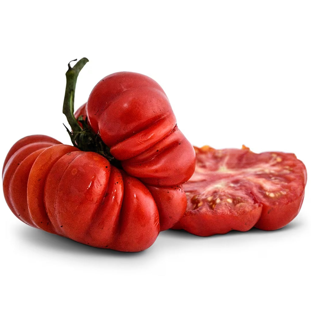 Red ribbed tomatoes, one whole and two sliced halves, with stems attached